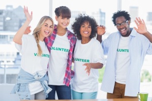 Group of volunteers standing together in a modern office